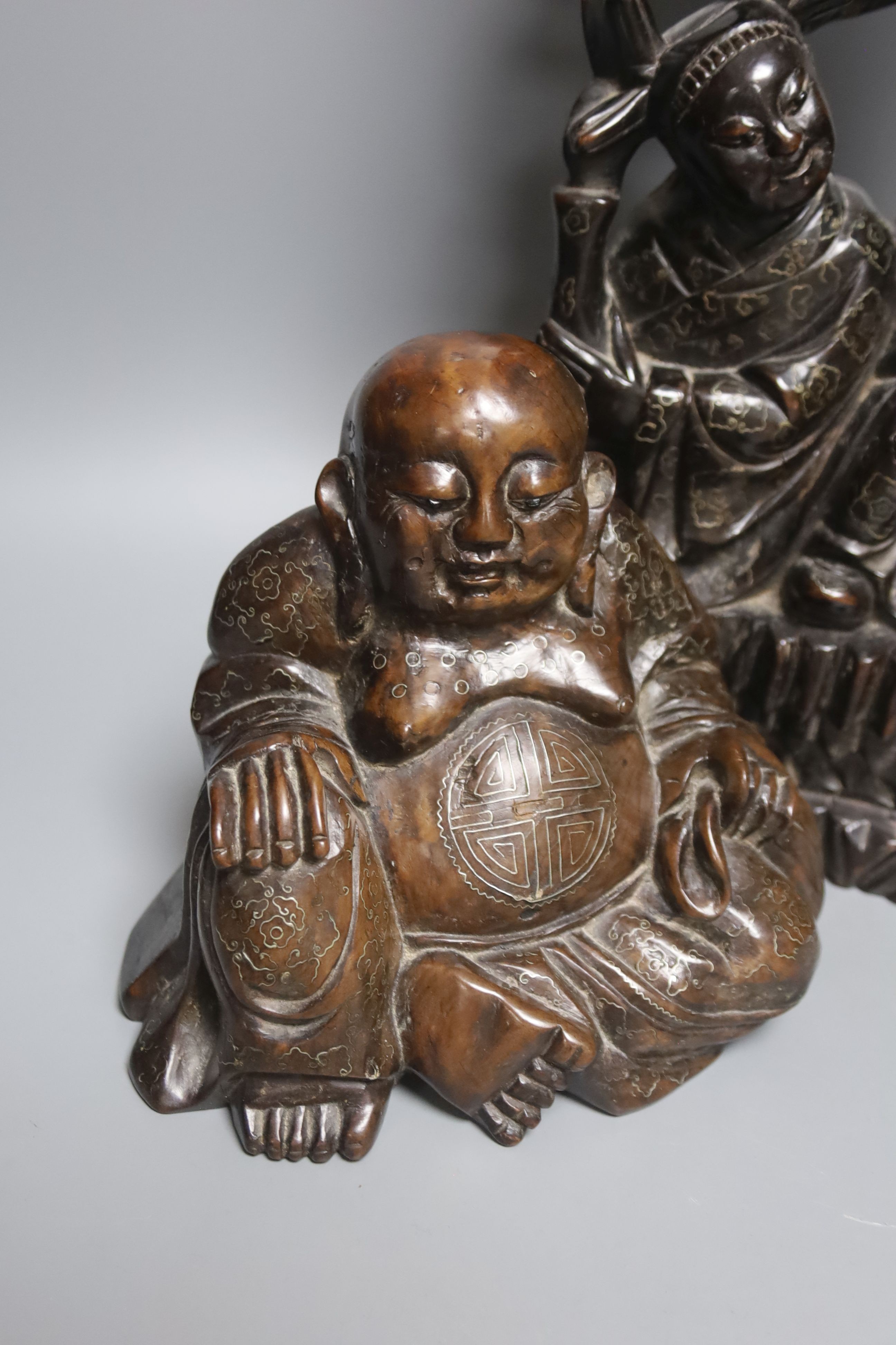 A Chinese hardwood and wire inlaid group of the He He Erxian and a similar figure of Budai, both early 20th century, tallest 49cm